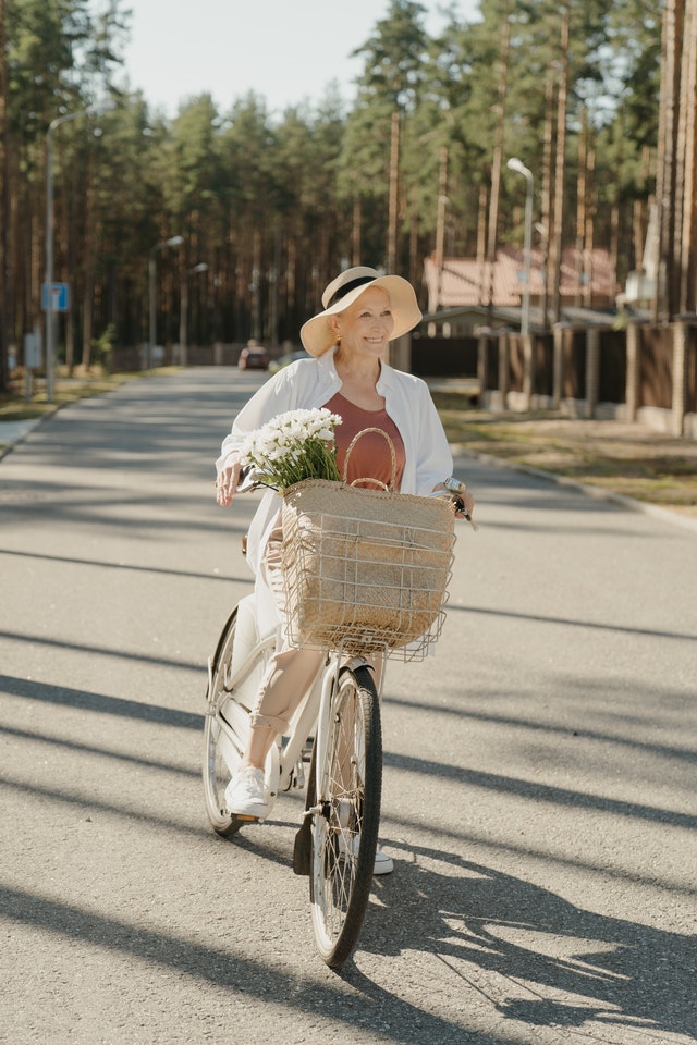 Senior woman getting exercise riding e-bike